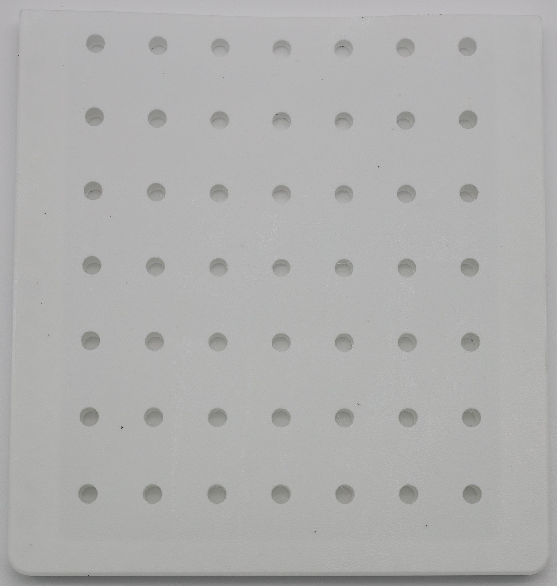 Battery separator close-up showing perforated structure for electrolyte flow